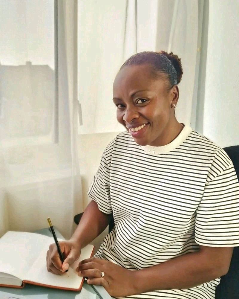 Vallessa Solo, founder of Beyond Paperwork, seated at her desk